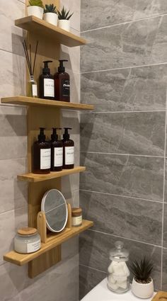 the shelves in the bathroom are holding various items