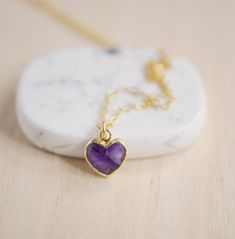 Give yourself some love or show your love for that special someone in your life with this heart necklace!Amethyst is believed to carry the energies of passion, creativity, and spirituality. It's also said to assist with temperance and sobriety, as well as inflammation.This necklace is handcrafted with a purple Amethyst faceted heart pendant. Each stone is natural and therefore contains natural inclusions or crystal formations. They are edged in 24k gold or silver electroplate. STONE SIZE: averag Spiritual Birthstone Necklace With Natural Stones, Heart Cut Amethyst Jewelry For Gifts, Spiritual Heart-shaped Necklace For Anniversary, Spiritual Gemstone Charm Necklace As Gift, Heart Pendant Amethyst Jewelry As Gift, Heart Shaped Amethyst Pendant Jewelry As Gift, Amethyst Heart Pendant Jewelry As Gift, Spiritual Heart Charm Necklace For Mother's Day, Spiritual Heart Pendant Necklace For Mother's Day