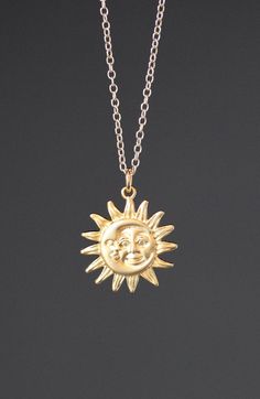 "This beautifully detailed 18k matte gold vermeil Sun and Moon charm dangles from a 14k gold filled chain. The chain is adjustable and can be worn close to the neck at 16\" or a little longer at 18\". It is finished with a gold lobster clasp. Please send a message if a longer chain is desired. Wear this necklace by itself or as a layering piece. Gold Sun and Moon pendant: 19mm Total length of charm: 1\" Gold chain: 1.5mm As the owner, maker, designer, and curator of this shop, I take great pride Celestial Yellow Gold Charm Necklace With Adjustable Chain, Celestial Brass Necklace With Sun And Moon Design, Gold Moon Charm Necklace With Sun And Moon Design, Gold Celestial Charm Necklaces In Brass, Celestial Gold Jewelry With Sun And Moon Design, Gold Celestial Charm Necklace In Brass, Gold Sterling Silver Necklace With Sun And Moon Design, Spiritual Gold Jewelry With Sun And Moon Design, Gold Symbolic Jewelry With Moon Phase