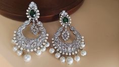 Sterling silver Crystal Emerald cubic zirconium kundan long drop earring / Diamond chandbali earring / Bridal CZ drop earrings  Making Time 10-15 Days These Celebrity Inspired Jhumka Earrings Are A Perfect Accessory This Wedding Season. Secured with a post and back Handcrafted To Perfection Perfect For Indian Weddings And Celebrations A Beautiful & Memorable Gift for Weddings and Special Occasions Fashion Empire Studio gives you new look, Made of high quality material(s).  This is very Designer Long Jhumki , Its A Choice Of Many Bollywood Celebrities.  Trust me, it is more Beautiful in Real another the Picture  This beautiful Set which is light in weight. The stones used are of high quality and the alloy used is led free. Designed By Master Craftsmen. Based On Indian beautiful Jewelry with Luxury Silver Chandbali Bridal Sets, Luxury Silver Chandbali Chandelier Earrings, Long Drop Earrings Diamonds, Silver Bollywood Chandelier Dangle Earrings, Bollywood Style Silver Chandelier Earrings With Cubic Zirconia, Silver Kundan Chandelier Dangle Earrings, Diamond Chandbali, Elegant Silver Kundan Chandelier Earrings, Fashion Empire