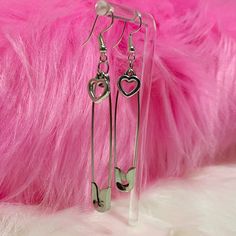 Take a fashionable risk with our Safety Pin Heart Earrings! These edgy earrings feature a heart charm attached to a safety pin, adding a cute and alternative touch to any outfit. Dare to be different and rock these unique earrings! Description: Item Type: EarringsEarring Type: Drop EarringsMetal Type: Iron AlloyOrigin: CNShape\Pattern: HeartMaterial: Metal Trendy Single Safety Pin Earring, Trendy Safety Pin Single Earring, Trendy Safety Pin Earrings For Pierced Ears, Trendy Everyday Heart Dangle Earrings, Emo Style Metal Earrings For Gift, Emo Metal Earrings For Gift, Trendy Paperclip-shaped Earrings As Gift, Trendy Paperclip Earrings As Gift, Trendy Paperclip Earrings For Gift