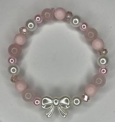 A pink bow bracelet Pink Bracelet Aesthetic, Bracelet Ideas Pink, Pink Bracelet Ideas, Coquette Bracelets, Pink Bead Bracelet, Pink Bracelets, Bracelets Christmas, Girly Bracelets, Pink Beaded Bracelets