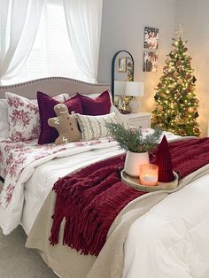 a bedroom decorated for christmas with red and white decor