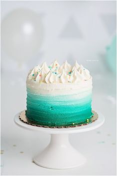 a cake with white frosting and blue icing