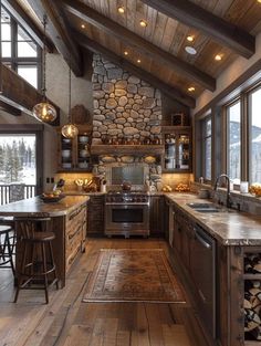 a rustic kitchen with wood floors and stone walls, along with an island in the middle