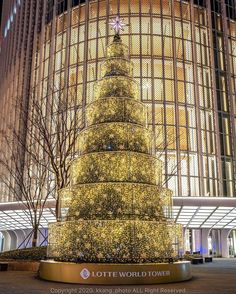 a large christmas tree in the middle of a building with lots of lights on it