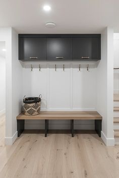 Mudroom details include white oak engineered wood flooring, custom wood top bench with open shoe cubbies, closed upper flip up cabinets with white panelling and gold coat hooks and cabinet cup pulls. Wallpaper And Shiplap, Gold Coat Hooks, Shoe Cubbies, Wyoming House, Modern Farmhouse Interior, Mantle Design, Modern Farmhouse Interior Design, Interior Door Hardware, Cabinet Cup Pulls