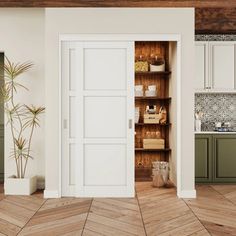 an open door to a kitchen with wooden floors