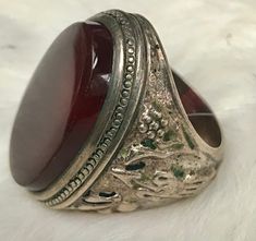 This ring is an estate sale find A stunning statement piece! It is not Marked but I had a Jeweler test it and he confirmed it is silver There is a beautiful oval large carnelian stone The silver is Embossed with birds and flowers on one side and what appears to be an arrow on the other. The ring Weighs  17 grams  with the Stone The size is about 10 1/4 I offer free shipping in the United States  all sales are final Vintage Rings With Large Stone For Collectible, Vintage Rings With Large Stone For Collectors, Vintage Collectible Rings With Large Stone, Vintage Silver Ring With Large Stone, Vintage Oval Jewelry With Large Stone, Vintage Round Rings With Large Stone, Vintage Oval Rings With Large Stone, Vintage Handmade Oval Engraved Ring, Handmade Vintage Oval Engraved Ring