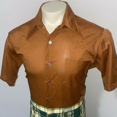 Armpit to armpit - 23.5 inches Length                - 30.5 inches You are bidding on a very groovy, vintage Hampshire House by Van Heusen short sleeve dress shirt. It is in very nice condition. The shirt is dark brown with clear buttons. The shirt has a wide collar, is button front, has one chest pocket. and is a dacron polyester/ cotton blend. The size stamp reads size 16.5 Half Sleeve (similar to a Mens Large), but exact measurements are provided. Pants are not included. Please email me with Retro Brown Top With Collar, Brown Fitted Tops With Spread Collar, Brown Fitted Top With Spread Collar, Fitted Brown Shirt With Button Closure, Brown Spread Collar Tops With Buttons, Retro Brown Short Sleeve Top, Brown Retro Short Sleeve Tops, Brown Fitted Button-up Shirt, Fitted Brown Button-up Shirt