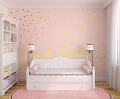 a baby's room decorated in pink and gold with polka dots on the walls