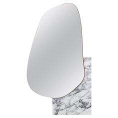 a mirror that is sitting on top of a marble slab with the reflection of an object in it