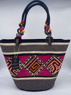 These beautiful handbags are made from Cana Flecha which is an indigenous palm fiber found in the northern territory of Colombia. They are beautifully hand crafted by the people from the Zenu tribes in Colombia. These handbags are colorful with vibrant colors, which is a pure reflection on the region and the warmness of these master artisans that work in this industry every day. Traditional Tote Beach Bag For Travel, Traditional Top Handle Straw Bag, Traditional Rectangular Vacation Bag, Traditional Rectangular Vacation Bags, Traditional Tote Bag For Vacation, Traditional Top Handle Bag In Natural Color, Traditional Top Handle Shoulder Bag In Natural Color, Handwoven Top Handle Shoulder Bag In Natural Fiber, Traditional Handheld Shoulder Bag For Beach