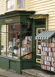 a book store on the corner of a street with books in it's windows