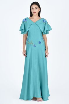 A romantic maxi dress with flutter sleeves and blue floral embroidery, perfect for celebrating special occasions. Embroidered Formal Dress With Cape Sleeves, Embroidered Evening Dress With Cape Sleeves, Evening Dress With Embroidered Cape Sleeves, Evening Dress With Embroidery And Cape Sleeves, Embroidered V-neck Maxi Dress For Evening, Summer Dresses With Embroidered Cape Sleeves, Embroidered Summer Dresses With Cape Sleeves, Summer Embroidered Dress With Cape Sleeves, Embroidered Summer Dress With Cape Sleeves