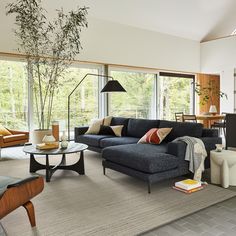 a living room filled with furniture and lots of windows