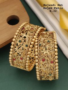 Description :- Indian bangle set/Metal bangles/Bridal Bangles/Designer bangle set for women/Wedding Jewelry/Festive Colorful Bangles/Bollywood jewelry set Gold Kada bangles /Indian bangles/Antique bangles/Temple Jewelry/Bridal Bangles/Indian Wedding/Pakistani Jewelry/South indian jewelry Gift yourself a royal look with this perfectly crafted necklace set from Manalisstudio. Crafted with high quality stones and pearls, it is impressive in design. The green enamel artwork adds perfect texture to t Bangles For Bride South Indian Weddings, Luxury Yellow Gold Temple Jewelry Bracelets, Luxury Gold Beads For Wedding, Gold Bangles Design Latest Indian, South Indian Bangles, Bangles Jewelry Designs Gold, Carved Stone Jewelry, Gold Indian Jewelry