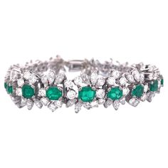 Indulge in the allure of our stunning 18K white gold bracelet, adorned with a captivating arrangement of emeralds and diamonds. The focal point of this elegant piece is the brilliant 4-carat emerald, flanked by four emeralds cascading in size from large to small on both sides.Surrounding these vibrant emeralds are meticulously set 16 carats of diamonds, showcasing a combination of round and marquise cuts. The bracelet's total weight of 35 grams signifies its substantial craftsmanship and luxurious feel. Selling Price: $ 23000.00 Elevate your style with this remarkable bracelet, a true embodiment of timeless beauty and sophistication. White Gold Bracelet, Marquise Cut, Emerald Diamond, Timeless Beauty, Diamond Bracelet, Gold Bracelet, Emerald, Jewelry Bracelets, Charm Bracelet