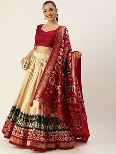 Step out in style this festive season with our fabulous off-white and maroon navratri lehenga choli! Designed with the perfect blend of traditional and modern elements, this ensemble is sure to make you the center of attention at any celebration.
The lehenga features an off-white color, crafted from lustrous tussar silk. With its sweeping 3.40-meter flair, expertly stitched with canvas and an attached cancan, this lehenga is designed to give you a graceful and elegant look. The inner lining of t Off White Sharara For Navratri, Festive Cream Choli, Off White Sets For Navratri With Traditional Drape, Off White Navratri Sets With Traditional Drape, Cream Traditional Drape Set For Navratri, Navratri Cream Traditional Drape Sets, Bollywood Style Off White Dupatta For Navratri, Off White Sharara With Pallu For Navratri, Cream Cutdana Lehenga For Navratri