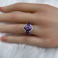 The key stone of this ring is a 11x9mm natural amethysts, and the main material of this ring is sterling silver plated with 18k white gold. On each side of the main stone are one 5x3mm and two 5x2.5mm amethysts. The small accent stones and zircon emphasize the big size of the key stone. Amethyst is a birthstone for February, and the color purple is meant to bring wealth and royalty. Also, many people believe amethyst has the power to relieve stress and purify the mind. Size: Adjustable and fitab Elegant Multi-stone Open Birthstone Ring, White Gold Crystal Ring With Gemstone, Anniversary Rings With Accent Stones And Open Design, Amethyst Cluster Gemstone Jewelry, Elegant Cubic Zirconia Gemstones For Promise Ring, Elegant Cubic Zirconia Gemstone Ring, Wedding Amethyst Gemstones With Diamond Accents, Luxury Multi-stone Crystal Ring For Anniversary, Timeless Gemstone Cluster Ring For Promise