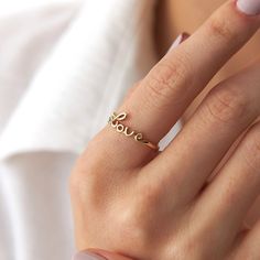 Our new lovely minimalist 14K solid gold love script ring. Simple and elegant. 14K solid gold is perfect for everyday use since it will not tarnish, and you don't have to worry about contact with conditioners or water. A perfect ring to stack as well.★ Ring Features• Gold Kt: 14Kt Solid Gold (All pieces are stamped for authenticity)• Available Gold Colors: Yellow Gold• Love Script Dimensions: 15.0 mm by 6.0 mm / 0.59 Inch by 0.24 Inch• Band Width 1.20 mm Word Ring, Love Script, Gold Ring Designs, Ring Simple, Gold Colors, Perfect Ring, Ring Designs, Gold Ring, Solid Gold