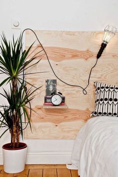 a bedroom with wood paneling and plants in the corner