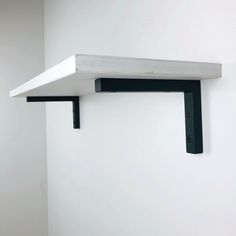 a black and white shelf on the wall