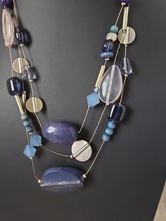 Elevate your style with this stunning Chico's necklace that exudes a boho vibe perfect for any occasion. The necklace features a mix of blue and clear glass beads, acrylic stones, and a floating/keepsake pendant shape that adds a unique touch to your look. The lobster closure and adjustable ball/bead chain make it easy to wear, while the 18-inch length and multi-strand layer design add a touch of elegance. This vintage necklace is perfect for females who want to add a pop of color to their outfit. The necklace is signed and comes with a seller warranty for your peace of mind. Don't miss out on this beautiful piece of jewelry that will surely make a statement. Bohemian Beaded Necklaces With Natural Stones For Party, Turquoise Glass Necklace For Party, Turquoise Glass Necklaces For Party, Blue Necklaces With Colorful Beads For Party, Blue Bohemian Necklaces For Party, Bohemian Glass Necklace For Party, Elegant Blue Necklace For Beach, Blue Glass Beaded Necklaces With Polished Beads, Blue Bohemian Necklace For Jewelry Making