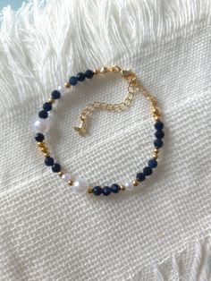 FOR OTHER DAINTY BEADED BRACELETS: https://www.etsy.com/ca/shop/ArtiChouXCanada?ref=seller-platform-mcnav%C2%A7ion_id§ion_id=46088511 Bracelet Length: 13-18cm (5.1-7 inches) with a 14k gold filled extender. But if you require a different size or prefer a personalized touch, please don't hesitate to get in touch. This bracelet features beautiful deep blue colors: blue sapphire gemstones, faux pearls and gold plated seed beads.  Thread may be visible since it is a handmade product   SIZING  Wrap a Blue And Gold Bracelets, Navy Blue Bracelet, Blue Bracelet Beads, Beaded Bracelets Blue, Gold Beads Bracelet, Blue Bead Bracelet, Simple Beaded Bracelets, Pearls Bracelet, Blue Beaded Bracelets