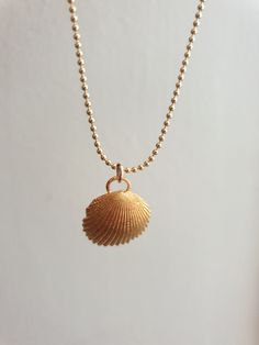 A sea shell necklace made of natural shells casted in brass and plated with quality, nickel free 14k gold plating. The necklace is made of 14k gold filled. Gold Minimalist Necklace For Beach, Minimalist Gold Necklaces For The Beach, Minimalist Gold Necklace For Beach, Handmade Gold Ocean-inspired Charm Necklaces, Handmade Ocean-inspired Gold Charm Necklaces, Dainty Gold Shell Jewelry, Gold Shell Necklace With Ocean-inspired Style, Gold Shell Necklace Ocean-inspired, Gold Shell Ocean-inspired Necklace