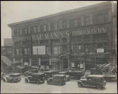 an old black and white photo of cars parked in front of a building with the words baumann's phostery on it