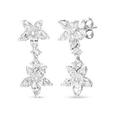 These enchanting marquise diamond floral dangle drop earrings are elegantly feminine, crafted in a design inspired by Mother Nature's artful handiwork. Sparkling, prong-set marquise diamonds form the basis of each blooming flower to become the very epitome of luxury and sophistication. Each earring boasts two flower silhouettes, adjoined by two prong-set round diamonds in a design styled for drama with a 1 1/3 inch length. These lustrous diamonds arte of a total 6 cttw and are of an approximate E-F color and VS1-VS2 clarity. The push back findings keep these pierced earrings safe and secure on your ears for comfortable wear for all of your favorite ensembles and special occasions. Flower Silhouette, Marquise Diamond, Earings Piercings, Prong Setting, Round Diamonds, Dangle Drop Earrings, Fine Jewelry, Fashion Jewelry, Drama