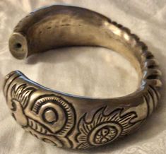 "Superb late 19th century Chinese silver cuff or wedding bracelet, silver, probably sterling or a lesser grade, not plated, hollow construction, circa 1890s, w lion motifs on the end. Nice weight and authentic period piece. The bracelet has an inside measurement of about 2 5/8\" across with a 1\" opening to easily wear and/or remove. It would fit a medium to large wrist. If you shake it you can hear a faint sound as if there is a teeny piece of metal inside. Total weight is approximately 45 gram Ornate Engraved Cuff Bracelet For Ceremonial Occasions, Antique Carved Bangle For Ceremonial Events, Antique Carved Bangle For Ceremonial Occasions, Antique Silver Engraved Cuff Bracelet, Antique Carved Ceremonial Bangle, Engraved Antique Silver Cuff Bracelet, Ceremonial Engraved Bangle Cuff Bracelet, Antique Round Cuff Bracelet For Ceremonies, Antique Silver Bangle For Ceremonial Occasions