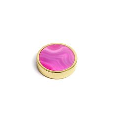 a round pink and gold object on a white surface with no one around it or in the background