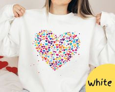 This fabulous heart-shaped sweatshirt makes a standout piece in your wardrobe. The stunning color combination enhances its visual appeal, making a bold statement that radiates positivity. The heart motif isn't just a graphic; it's a celebration of love, self-expression and joy. *Product Details* *crewneck style *professional printed *soft and cozy *no itchy side seam *unisex sweater *Materials* *50% Cotton 50% Polyester- a perfect combination of comfort and durability  *Sizing and Colors* *please refer to sizing and color charts in the images *runs true to size *size up for an oversized sweater look  *Care Instructions* *turn inside out and machine wash cold on delicate cycle *avoid dry cleaning, bleaching, or directly ironing the garment *Processing and Shipping Times* *Please allow 2-5 b Valentine's Day Gift Cotton Sweatshirt, Valentine's Day Cotton Sweatshirt Gift, White Crew Neck Sweatshirt With Heart Graphic, Heart Graphic Long Sleeve Top As Gift, Casual Heart Graphic Sweatshirt Gift, Long Sleeve Tops With Heart Graphic For Gift, White Crew Neck Sweatshirt For Valentine's Day, Valentine's Day White Crew Neck Sweatshirt, White Casual Sweatshirt For Valentine's Day