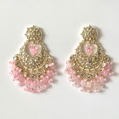 "Bollywood kundan earrings with beaded detailing and pearls add stylish flair to these gold embellished statement pieces! Length 3.5\" | Width 1.5\" Items are carefully packed and ready for gifting. All pictures are taken in natural light please allow for slight variations in color due to camera settings. Jewelry Care ✨Protect your jewelry in a closed box or pouch   ✨Wear jewelry after you have applied lotion or perfume ✨Gently buff with a soft cotton cloth  Visit our website: www.desimoon.etsy. Dangling Pearl Earrings For Wedding And Festivals, Kundan Chandbali Bridal Earrings, Festive Bridal Earrings With Dangling Beads, Festive Wedding Earrings With Dangling Beads, Kundan Earrings With Dangling Beads For Celebration, Beaded Chandelier Earrings For Weddings And Festivals, Chandbali Earrings With Dangling Beads For Wedding, Kundan Dangle Chandbalis For Reception, Bridal Kundan Earrings With Dangling Beads For Celebration