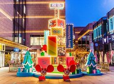 a brightly lit christmas display in the middle of a shopping mall