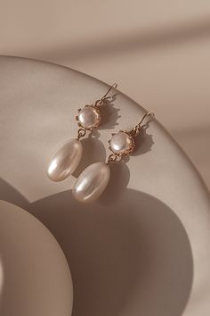 The design of Mira features a freshwater drop pearl suspended from a pearl encased in a 14k gold-filled bezel cup.The gold hook on these earrings is extra fine and comfortable to wear.  A timeless and versatile accessory, these earrings are suitable for any occasion, from formal events to casual outings. Packaged in an elegant plastic-free reusable jewelry box, they make the perfect gift or special treat for oneself.  14k gold-filled components Freshwater pearls Hypoallergenic, suitable for even Elegant Drop Pearl Earrings In 14k Gold Filled, Elegant 14k Gold Filled Pearl Drop Earrings, Elegant 14k Yellow Gold Filled Teardrop Earrings, Classic Pearl Pendant Earrings In 14k Gold Filled, Elegant 14k Gold Filled Teardrop Earrings, Gold Pearl Earrings For Everyday Elegance, Elegant Pearl Charm Earrings In 14k Gold Filled, Everyday Elegance Gold Pearl Earrings, Elegant Drop Pearl Earrings With Ear Wire