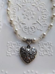 This handmade piece brings a fun elegant twist on the vintage Y2K heart pendant. The heart hangs between hand a beaded strong of white and clear beads and faux vintage pearls. A trendy Y2K necklace to bring a little style and romance to your life. Y2k Heart, Y2k Necklace, Clear Beads, Vintage Pearls, Heart Pendant Necklace, Pendant Necklaces, Heart Pendant, Vintage Y2k, Jewelry Necklace Pendant