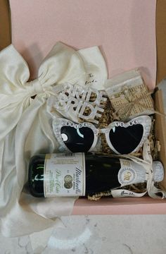 a wine bottle and sunglasses in a gift box