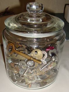 a glass jar filled with lots of keys