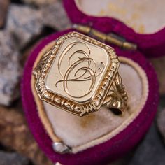 This antique signet ring features the initials "OO" in script on the rectangular shaped top. The shoulders are decorated with beautiful scrolling and patina. The ring is crafted in 14k yellow gold and is a size 10.5. We are not offering resizing due to the hand engraved inscription on the inside if the shank that reads "Minnie Fira Reidar de Wenke." Luxury Antique Signet Ring With Brilliant Cut, Luxury Vintage Diamond Cut Signet Ring, Luxury Engraved Victorian Signet Ring, Floral Signet Ring, Rectangular 14k Stamped Signet Ring Collectible, Classic Rectangular Signet Ring Stamped 14k, Signet Ring Initials, Collectible Yellow Gold Signet Ring With Initials, Luxury Anniversary Signet Ring With Maker's Mark