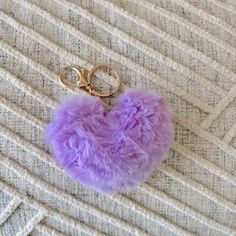 a fluffy heart shaped keychain with two rings