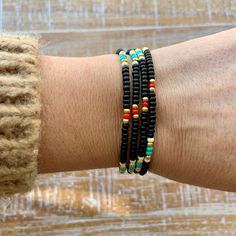 "Black, turquoise, red, white and gold beaded wrap style bracelet is 28\" long and will wrap around on average wrist (6.5-7\") four times. It comes with 1\" chain extender. It could be worn also as a necklace. Details: - Adjustable wrap style bracelet: 28\" long with 1\" chain extender, full length 29\" designed to fit 6.5-7\" wrists, - Listings include one bracelet - Bracelets may vary in exact pattern. Slight variations due to the individuality of each piece - This item should be kept away fro Black Heishi Beads Bracelet With Colorful Beads, Black Heishi Beads For Beach, Black Heishi Beads Bracelet As Gift, Beach Jewelry With Black Heishi Beads, Bohemian Black Heishi Beads Bracelets, Bohemian Black Heishi Beads Bracelet, Black Bohemian Heishi Beaded Bracelet, Black Heishi Beads Bohemian Bracelet, Black Round Beads Jewelry For Beach