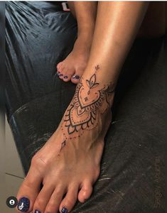 a woman's foot with tattoos on it