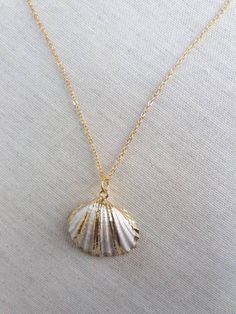 Beautiful gold shell necklace made with a gold plated seashell charm with a 24k gold filled chain. This necklace makes a unique gift for a beach lover or someone special in your life. The seashell is around 25-30mm long. Each item is carefully packaged in a beautiful jewellery box ready as a gift. If you would like to add a personalized note with your order, just write a note at checkout and I will send a small card with your gift to the recipient. Please choose necklace length from the drop-dow Ocean-inspired Gold Shell With Lobster Clasp, Gold Shell Necklace Ocean-inspired, Gold Ocean-inspired Shell Necklace, Gold Shell Necklace With Ocean-inspired Style, Gold Shell Ocean-inspired Necklace, Gold Ocean-inspired Shell, Dainty Gold Shell-shaped Necklace, Dainty Gold Shell Charm Necklace, Ocean-inspired Gold Shell Charm Necklace