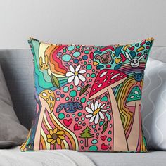 a colorful throw pillow sitting on top of a couch