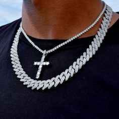 Bring the bling AND the blessings, with the oh so icy Diamond "Prong-Set" Cuban AND Iced Cross Tennis Chain Bundle! This 3-in-1 package offers insane value, featuring our timeless Iced Diamond Cross Pendant, exquisitely paired with a Round Cut Diamond Tennis Necklace AND the very heavy-hitting 12mm Diamond Prong Cuban Link Necklace. Claim the light and catch the light with every single angle from Heaven to Earth! Specifications Length: 18" and 18" or 18" and 22" Width: 12mm and 3mm Material Opti Diamond Cross Chain Men, Cuban Necklace For Men, Iced Chain, Ice Chain, Diamond Chains For Men, Chains Men, Chains Cross, Cuban Link Chain Men, Mens Chains