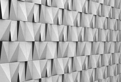 a wall made up of many different shapes and sizes, all in grey color with white background