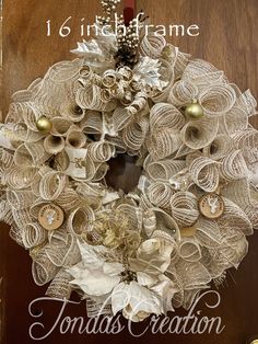 a christmas wreath made out of old book pages and other things is hanging on the door